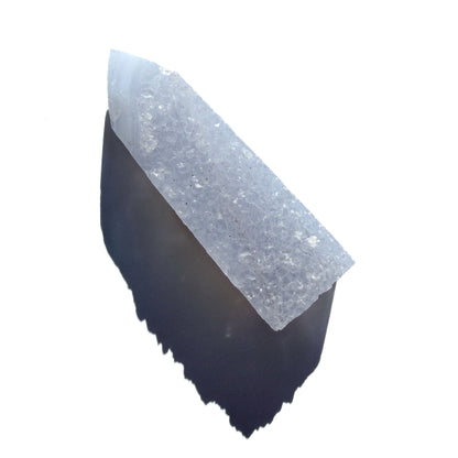 blue chalcedony crystal tower on a white background with shadow.