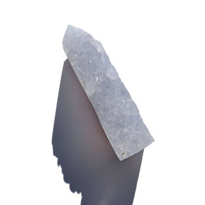 blue chalcedony crystal tower on a white background with shadow.