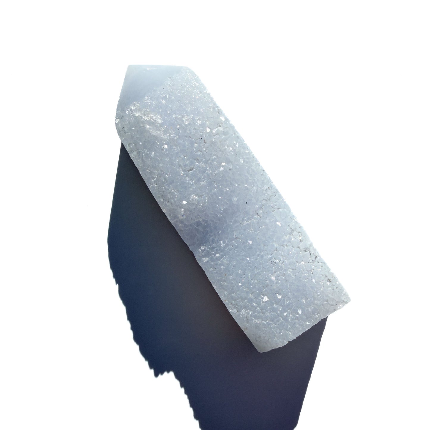 blue chalcedony crystal tower on a white background with shadow.